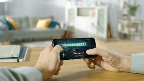 POV Person Holding Smartphone Plays Mock-up Racing Game, Driving Through Neon Cityscapes and Drifting Through Tunnels. Game Features Multiplayer Battles and High-speed Chases. Racing Drift Simulator. - Powered by Shutterstock - Get 15% off with code: PIKWIZARD15