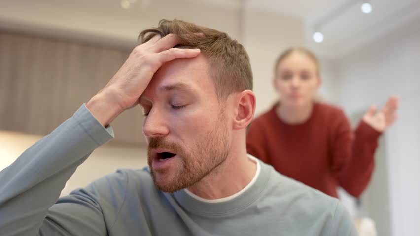 Enraged furious woman shouts pushing stressed man to breaking point, fed up man holds head overwhelmed. Male exhausted from endless arguments nagging, emotional burnout, toxic relationship, the end