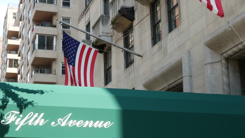 Fifth avenue, 5 ave sign, Manhattan midtown architecture, New York City 5th av. Real estate, residential property in USA. Classic building entrance signage. United States of America flag.