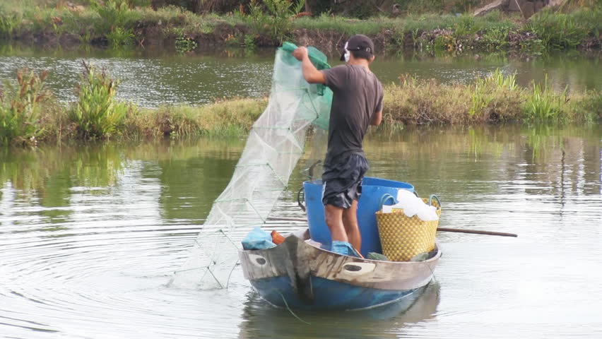 HOI AN, VIETNAM - JULY 3:  Fisherman pulling in his net
