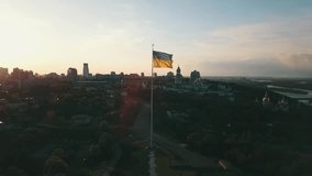 The flag of Ukraine flutters in the wind in the center of Ukraine in Kyiv - Powered by Shutterstock - Get 15% off with code: PIKWIZARD15