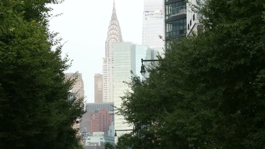 New York City Manhattan Midtown architecture from Queens. Chrysler building, iconic high-rise skyscraper, USA street. American urban cityscape, NYC Vanderbilt tower. Long Island, United States. Fog.