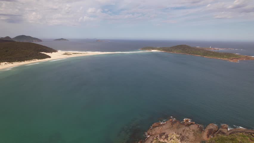 Panoramic View Of Fingal Bay With Fingal Beach And Island Connected By Sand Spit In New South Wales, Australia. aerial panning shot