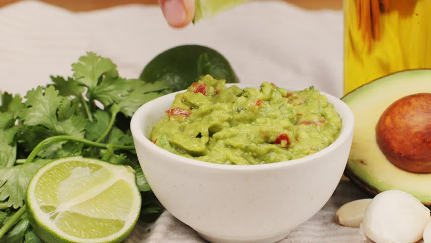 Guacamole dip, traditional mexican food in restaurant for nachos, close up of avocado plate for vegetarians.