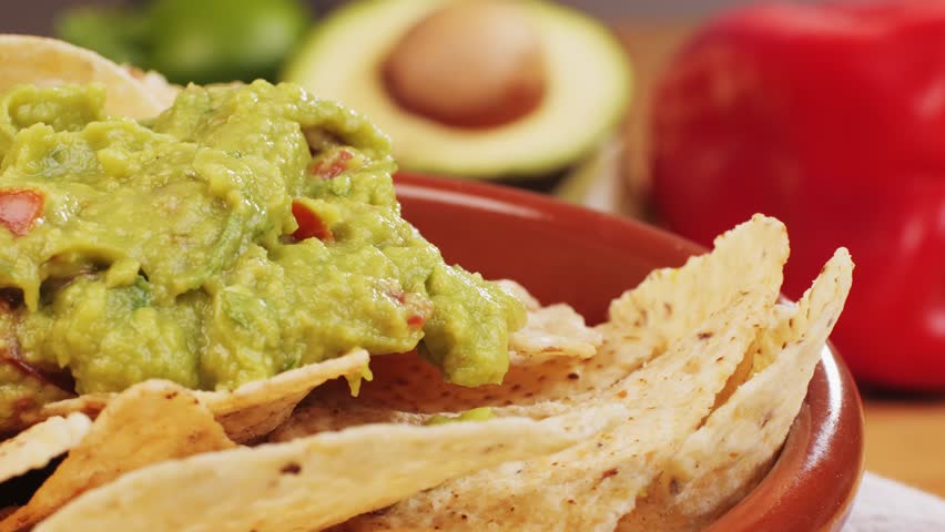 Nachos with Guacamole dip, traditional mexican food in restaurant for nachos, close up of avocado plate for vegetarians.