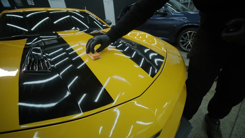 Car Detailing Specialist Washing a Yellow Sports Car