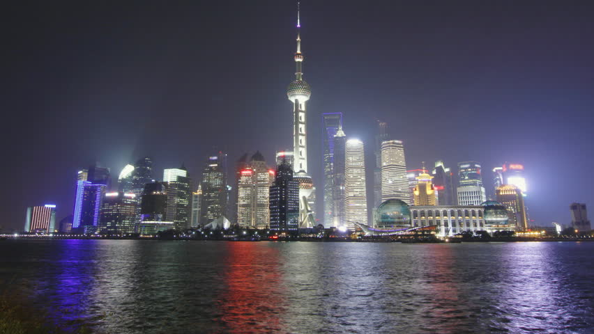 Time lapse of Shanghai skyline and tour boat passing in the Huangpu river at