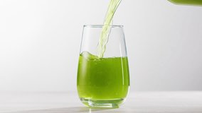 Fresh Green detox juice with cucumber, celery, apple and ginger and mint in glasses and jars. Pouring Vegan juice detox concept. - Powered by Shutterstock - Get 15% off with code: PIKWIZARD15