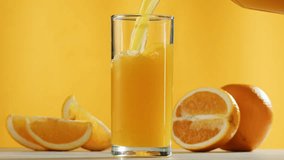 Woman pouring orange grapefruit juice from juicer into glass on colorful background, citrus vitamic c healthy fresh juice in cafe, morning breakfast drink. - Powered by Shutterstock - Get 15% off with code: PIKWIZARD15