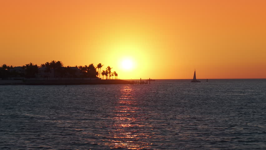 Capture the stunning sunset over Sunset Key Island, Key West, Florida, showcasing vibrant colors and peaceful ocean watersa perfect scene for relaxation and nature appreciation