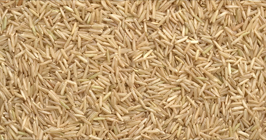 Himalayan brown basmati rice background texture. Flat lay, table spin.