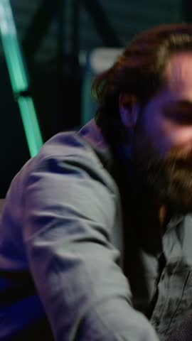 Vertical video Supporter watching sports match on live broadcast, raging on couch in anger seeing team mistake. Angry man looking at football competition fuming, releasing pent up emotions, camera A