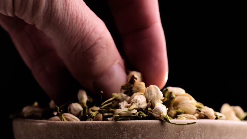 Dried Jasmine flower tea macro background. Heap pile of Jasmine buds, herbal Tea ingredients. Fragrant Natural Pure Jasmine Buds Organic Dried Jasmine Flowers.