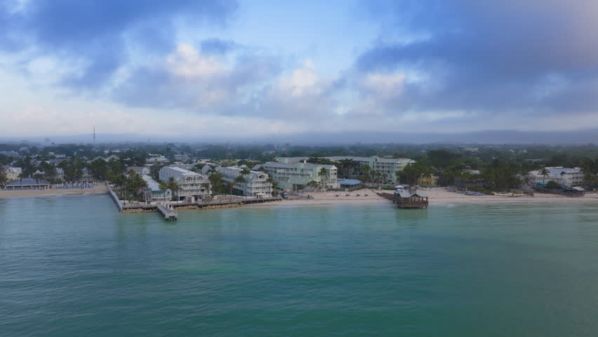Experience the breathtaking aerial view of Key West, Florida, showcasing exquisite Sunset Key and stunning coastal vistas of calm, crystalclear waters and inviting beaches