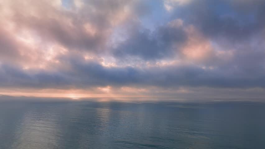 Experience the stunning aerial view of a Key West sunset, with vibrant colors reflecting off calm waters and fluffy clouds, creating a picturesque scene of tranquility and paradise