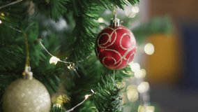 Hanging red ornament on Christmas tree with Season's Greetings animation overlay. Holidays, festive, decoration, celebration, tradition, winter - Powered by Shutterstock - Get 15% off with code: PIKWIZARD15