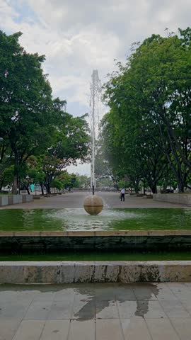 Vertical aerial shot capturing the fountain in Plaza Juarez, located next to blue water Park in Guadalajara, Mexico