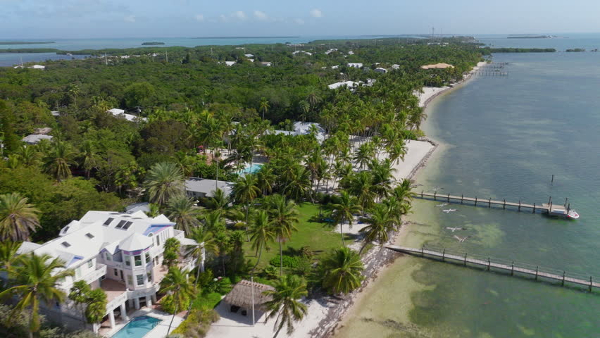 Experience the breathtaking aerial view of Key West, Florida, with its lush landscapes, sandy beaches, and crystalclear watersa perfect tropical escape thats hard to resist