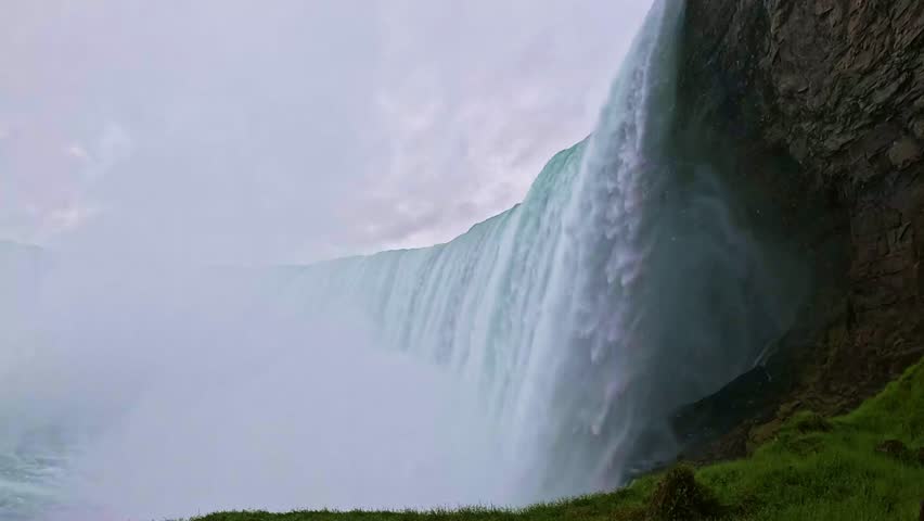 Powerful Close-Up View of Niagara Falls stunning close-up of Niagara Falls, showcasing powerful cascading water and mist rising from falls against rocky cliff.