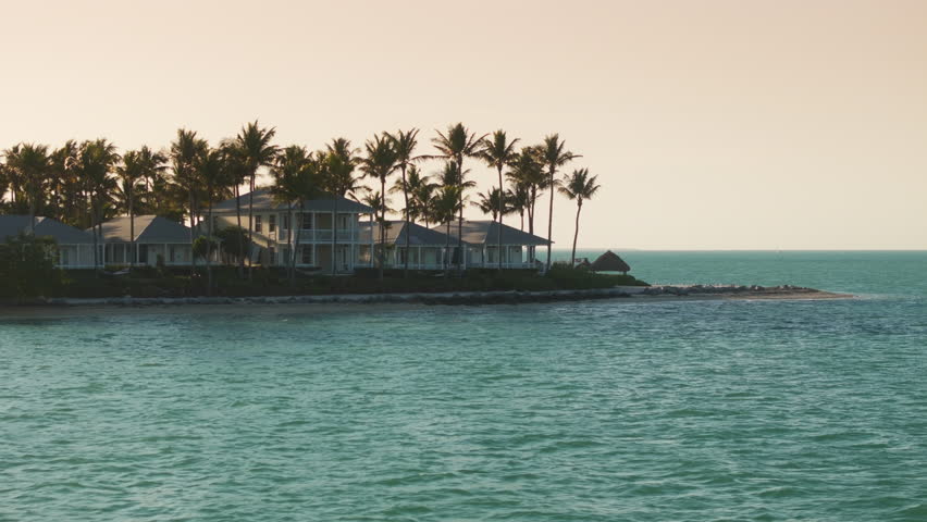 Experience the breathtaking and stunning aerial views of Sunset Key Island located in Key West, Florida, which showcases its remarkable scenic beauty and wonderfully serene atmosphere