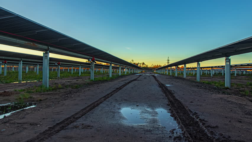 Economic growth charts overlaying a solar farm, renewable energy market trends increasing as light crosses and panels rotate - Powered by Shutterstock - Get 15% off with code: PIKWIZARD15