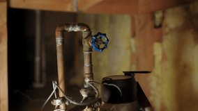Close up view of plumber hand adjusting a valve on a copper water pipe system under a kitchen sink. Home plumbing repair and maintenance concept. - Powered by Shutterstock - Get 15% off with code: PIKWIZARD15