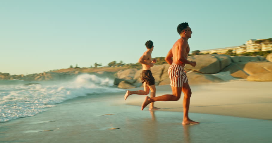 Vacation, men and friends with handshake at ocean for greeting, travel and running with waves. Outdoor, sea water and people at beach for welcome, summer holiday and splash with energy at sunset