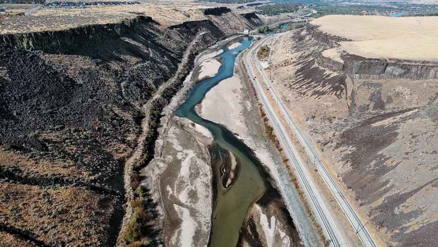 Drone shot of Boise River Canyon, showcasing steep rock formations and the meandering river through the vast wilderness