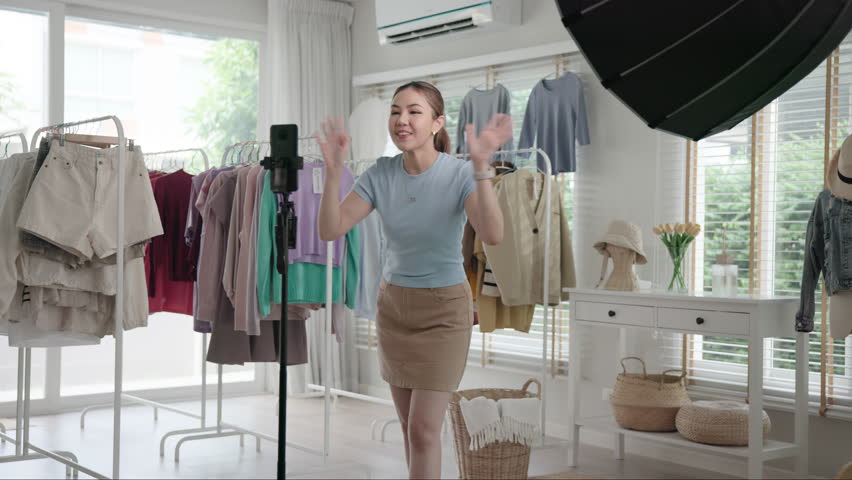 Gen Z vlogger SME owner go green net zero thrift store sale live stream talk on mobile social media online second hand sell. Asia people young woman record home video camera app eco shop side hustle.