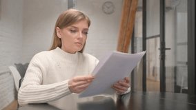 Paperwork by Creative Young Woman Reading Documents at Workspace - Powered by Shutterstock - Get 15% off with code: PIKWIZARD15