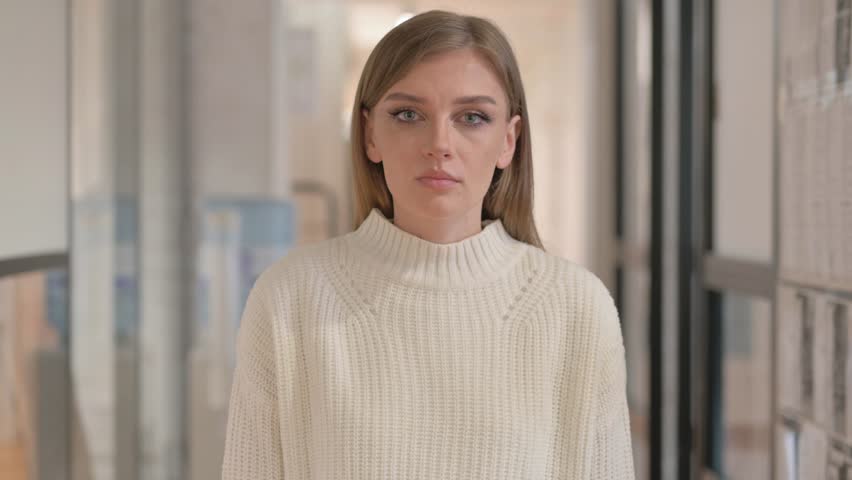 Portrait of Young Woman Asking for Silence, Finger on Lips