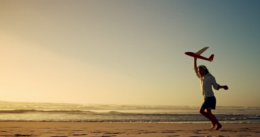 Kid, running and airplane toy on beach with flying game, imagination travel and summer vacation. Girl, child and energy with plane for playful flight, freedom fun and tropical holiday of getaway trip