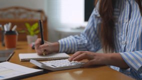 Professional accountant diligently calculating financial data, taking detailed notes while working at modern office desk, demonstrating precision and focus in financial management process - Powered by Shutterstock - Get 15% off with code: PIKWIZARD15