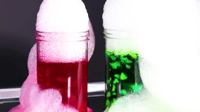 A vibrant science experiment with dry ice creating colorful bubbles in red and green liquids, showcasing chemical reactions - Powered by Shutterstock - Get 15% off with code: PIKWIZARD15