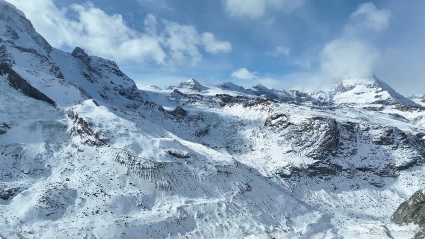 Aerial drone fly around Matterhorn Glacier Paradise during winter in Switzerland. Majestic mountain peaks iconic famous zermatt travel ski resort in the alps. Wonderful inspiring nature landscape.