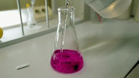The colored liquid is poured into a chemical flask. Chemical industry - Powered by Shutterstock - Get 15% off with code: PIKWIZARD15