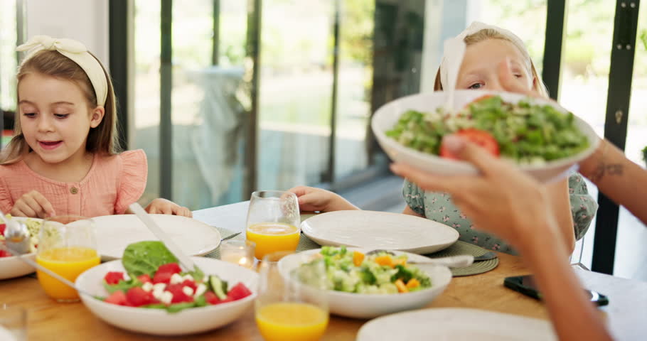 Children, happy and family lunch with food, helping hand and plate for salad, bonding and love at Easter. Girl, kids and or for nutrition, health and diet with care for holiday with thanks in home