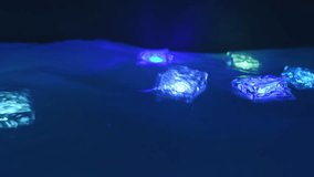 Glowing decorative cubes float on the water in the dark, changing colors. Neon lighting creates a cozy and relaxing atmosphere. - Powered by Shutterstock - Get 15% off with code: PIKWIZARD15