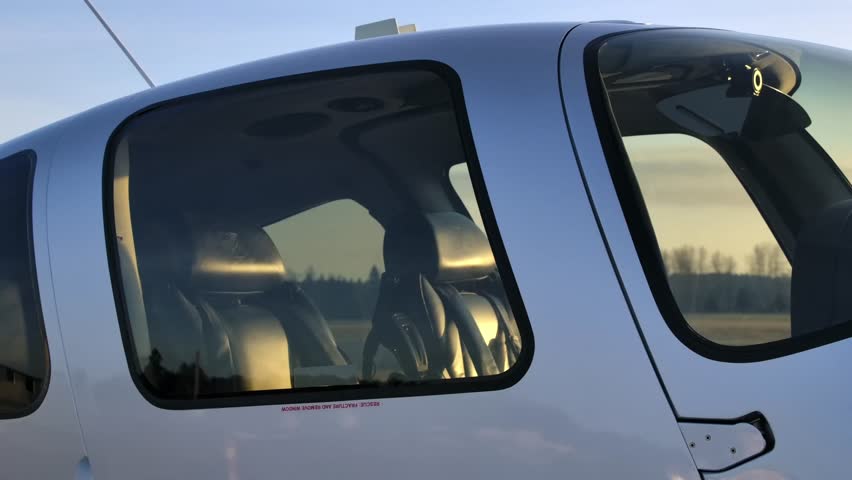 Cockpit and Cabin Plexiglas Windows of a Propeller Airplane Close Up
