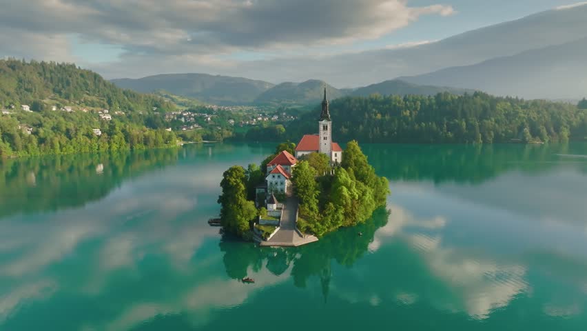 Spring morning in Bled lake, Slovenia, aerial shot. Church on small island in Lake Bled, Slovenia, with mist rolling across the water during sunrise