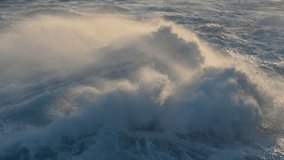 Huge power ocean wave crashing over sunset sky background. Slow motion of stormy ocean surf splashing on the coast of Madeira, Porto Moniz - Powered by Shutterstock - Get 15% off with code: PIKWIZARD15
