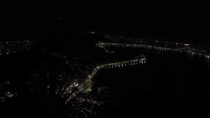 Aerial cityscape of Rio de Janeiro Brazil city illuminated at night near Christ the Redeemer