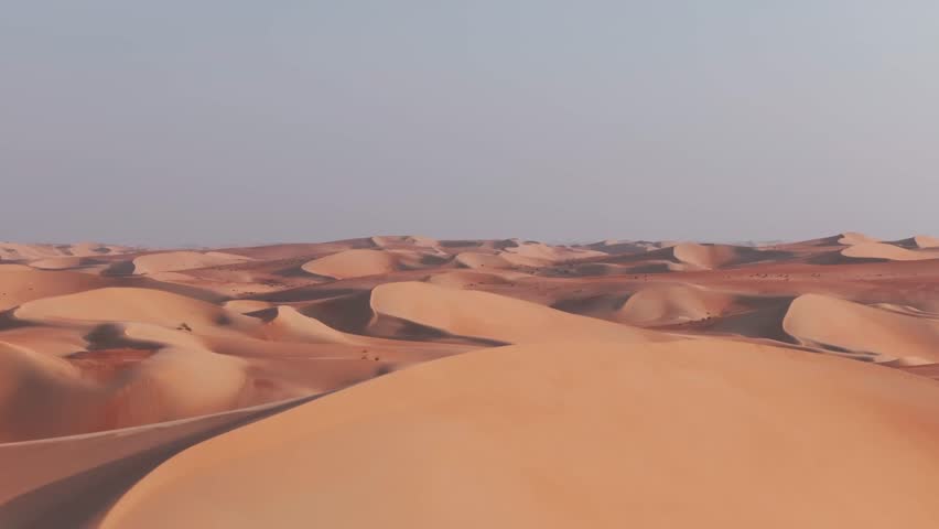 Side drone shot of big dunes in empty desert