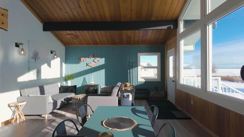 Escape to a vibrant vacation home on the lake in Alberta, featuring a modern and colorful interior with breathtaking waterfront views