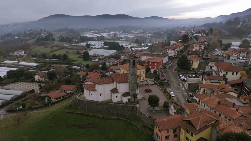 Brovello-Carpugnino, church with bell tower, Piedmont in Italy. Aerial drone view