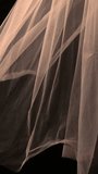 A white translucent veil blowing in the wind. Wedding veil on a dark background - Powered by Shutterstock - Get 15% off with code: PIKWIZARD15
