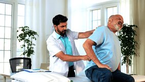 Indian Asian male physiotherapist examining senior retired patient with chronic back pain in lavish clinic, ensuring precise diagnosis and effective rehabilitation for pain relief, improved mobility. - Powered by Shutterstock - Get 15% off with code: PIKWIZARD15