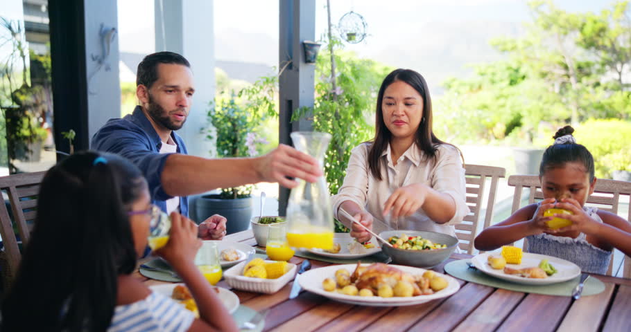 Family dinner, parents and serving with salad for happy conversation, love or bonding together on patio. Father, mother and daughter for lunch, chat or relax with care, smile or laugh outside house