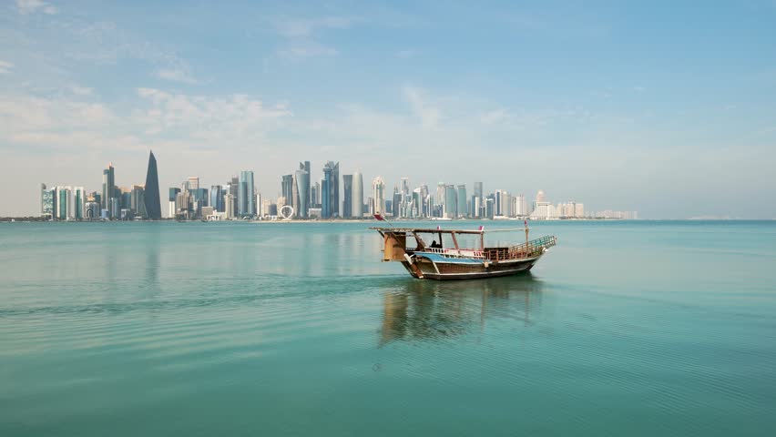 Traditional Arabic Dhow boats in Doha harbour, Qatar. beautiful seascape with the sea and modern skyscrapers on the background.