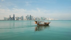 Traditional Arabic Dhow boats in Doha harbour, Qatar. beautiful seascape with the sea and modern skyscrapers on the background. - Powered by Shutterstock - Get 15% off with code: PIKWIZARD15